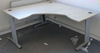 A beech corner office desk raised on metal legs, 160x160x80cm.