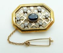 A yellow metal brooch set with an oval cut sapphire and diamonds in lattice setting, 6.4g, 2.8 x 1.
