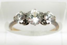 An 18ct gold ring set with three white sapphires, 2g, size J