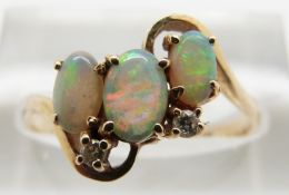 A 14ct gold ring set with opals and two diamonds, 2.3g, size O