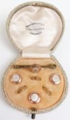 A boxed set of rolled gold buttons and a brooch set with mother-of-pearl in Henry Jones & Co box