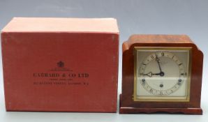 Elliott walnut cased mantel clock with Garrard and Co. to silvered Roman dial, trefoil hands and