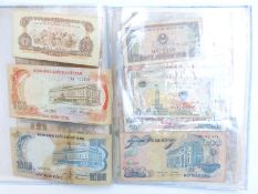 An album containing Asian and Indo China banknotes together with a reproduction Indo China -