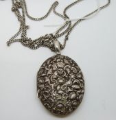 Victorian white metal locket with embossed floral and foliate design on a white metal fob/guard