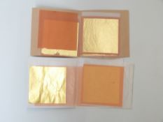 A quantity of 22ct gold leaf between protective sheets of paper with label 