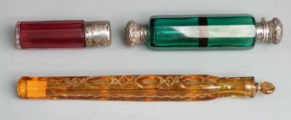 Three glass scent bottles comprising one with cranberry glass faceted body and hallmarked silver
