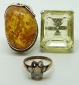 Two silver rings, one set with pressed amber and the other citrine and another silver gilt ring