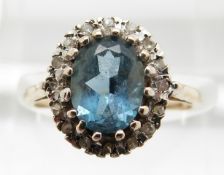 A 9ct gold ring set with an aquamarine surrounded by diamonds, 2.9g, size M