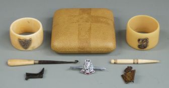 Two Victorian hallmarked silver mounted napkin rings, Bullseye boot charm, two military badges etc