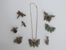 Two silver brooches in the form of butterflies set with marcasite, two silver brooches in the form