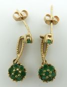 A pair of 9ct gold earrings set with emeralds