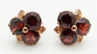 A pair of 9ct gold earrings set with garnets