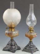 Two oil lamps with cast bases