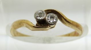 An 18ct gold ring set with two old cut diamonds, 2.1g, size K
