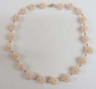A necklace made up of pearls in clusters with 18ct gold clasp, 22.5cm drop