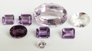 Four emerald cut amethysts, oval cut amethyst, a round cut white sapphire, oval cut quartz and a