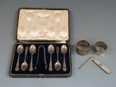 Cased set of six hallmarked silver teaspoons and tongs, two hallmarked silver napkin rings and a