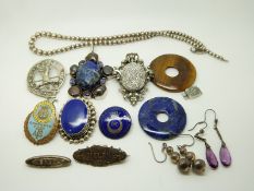Two silver brooches, a silver pendant, two silver earrings, a silver necklace, a lapis lazuli disc
