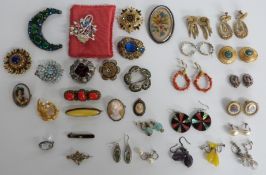 A collection of brooches including Miracle, enamel and filigree brooch, quartz brooch, porcelain