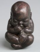Possibly Eastern Bronze model of a baby, length 7.5cm