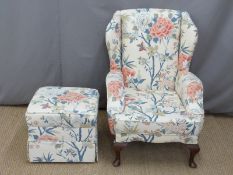 Upholstered blue patterned back armchair and matching footstool
