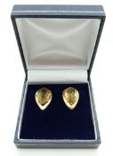 A pair of 9ct gold earrings set with a pear mixed cut citrine to each