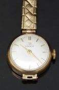 Tissot 9ct gold ladies wristwatch with gold hands and baton markers, silver dial and signed 15 jewel