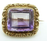 Victorian brooch/ pendant set with a large mixed cut amethyst within a scrolling border, 15.4g, 3