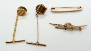 Two 9ct gold brooches, one in the form of a horseshoe and boomerang, 2.6g, 9ct gold pin set with
