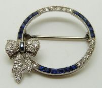 Art Deco platinum circular brooch set with diamonds and sapphires, with bow decoration, 2.8cm