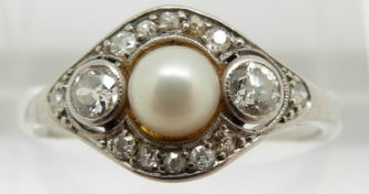 Art Deco platinum ring set with a pearl, two diamonds each approximately 0.1ct and further diamonds,