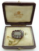 Georgian/Victorian mourning brooch set with plaited hair to the central glass compartment surrounded