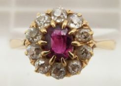 Victorian 18ct gold ring set with an oval cut ruby surrounded by old cut diamonds, 3.3g, size N