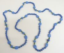 A ceramic necklace decorated with 23 carved scarab beetles and further blue and green carved