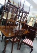 A mahogany extending dining table and eight chairs, all raised on ball and claw feet, W58 x H73 x