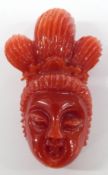Chinese carved coral figure in the form of a lady's head, 3.5cm long.