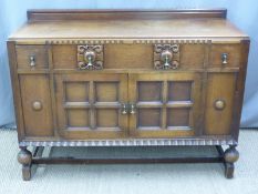An oak sideboard with three drawers over a two door cabinet W132 x D50 x H96cm