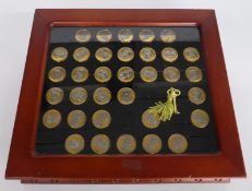 Thirty three coated USA one dollar coins in deluxe case.