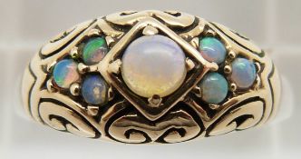 A 9ct gold ring set with opals in a scrolling setting, 3.7g, size L