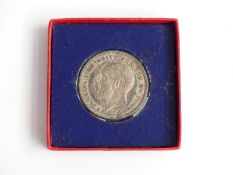 George V proof 1935 rocking horse crown with raised edge inscription, in original box