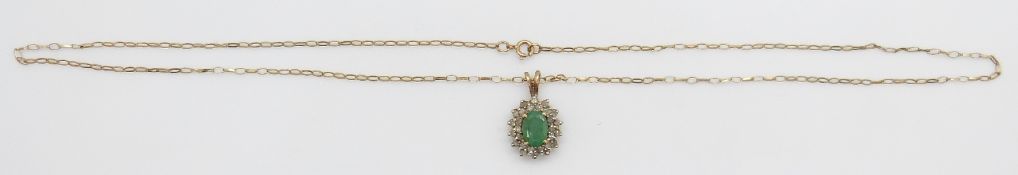 A 9ct gold pendant set with an emerald and diamonds on a 9ct gold chain, 2.1g