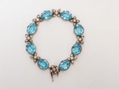 A silver 1950s bracelet set with blue and clear paste