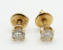 A pair of 14k gold earrings set with a diamond measuring approx 0.25ct each