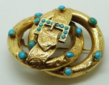 Victorian knot and buckle brooch with engraved chased decoration set with turquoise cabochons, in