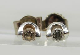 A pair of 9ct white gold earrings set with a 0.05ct diamond to each by Canadian Ice in original box