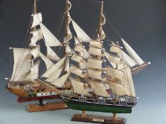 Two model sailing ships on stands, height of taller 60cm