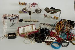 A collection of costume jewellery including agate beads, beaded necklaces, Victorian dress watch