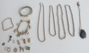 A hallmarked silver bangle in Perry Greaves Birmingham box, silver charms and bracelet including a