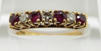 An 18ct gold ring set with alternating rubies and diamonds, 2.9g, size L