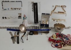 A collection of costume jewellery including brooches, necklaces, silver plated belt, etc